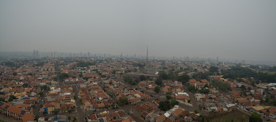 An aerial photo of the city of Campo Grande - MS, Brazil, with a gray sky, with a lot of smoke due to fires in times of drought throughout the country. Photo taken on September 14, 2024.