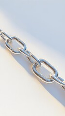 Obraz premium A broken chain link symbolizing freedom and breaking barriers, placed on a smooth surface with a light solid color backdrop