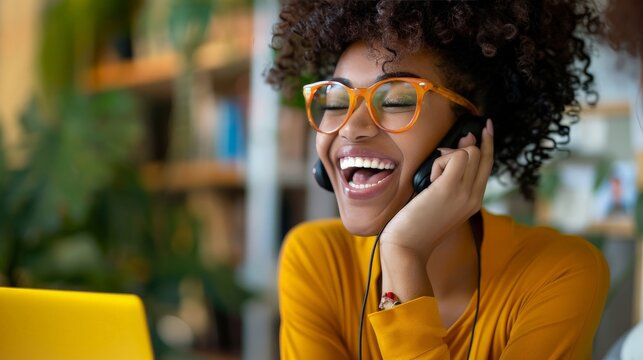 A young woman getting her first job offer over the phone, ecstatic