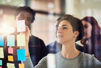 Business woman, glass and sticky note for brainstorming, planning and collaboration objectives with...
