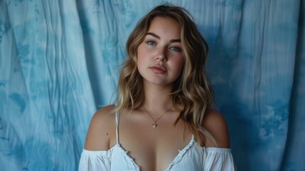 Naklejka premium portrait of beautiful woman with blue curtain type background