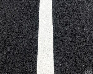 A close-up of a smooth asphalt road with newly painted dashed lane markings, creating a pristine look lane markings, asphalt, smooth surface