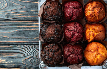 Mix of muffins ( cupcake ) chocolate , vanilla , berries . Top view