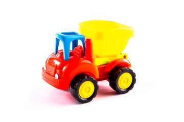 Dump truck toy isolated on white background. Construction industrial equipment for transporting materials