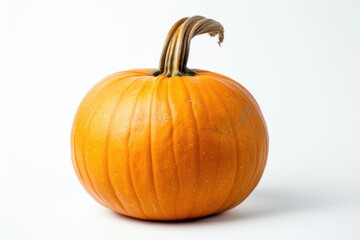 Obraz premium A small orange pumpkin sits on a white surface, perfect for fall or Thanksgiving decorations