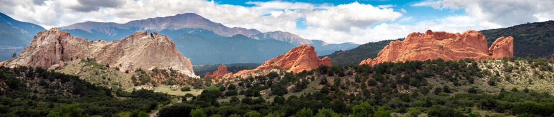 Beautiful panormaic view of Garden of the Gods in Colorado Springs. The Red Rock stone formations rise hundreds of feet above the desert floor. In the distance you can see Pikes Peak.
