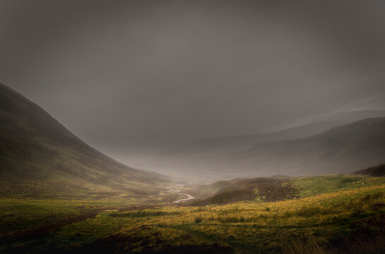 A dreich, misty, summer HDR image of Gleann Beag, the small valley, with rain falling and low cloud, Perthshire, Scotland.