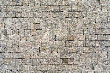 A Weathered Granite Cobblestones background in Earthy Tones. Features a rough texture in beige and gray. Ideal for retro designs, websites, brochures, or as a textured backdrop for text placement.