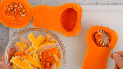 Butternut squash soup recipe. Raw vegetables close-up on the kitchen table. Peeled  and seedless butternut squash close-up on a cutting board