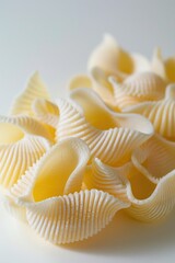 A close-up of cooked pasta shells on a white surface, suitable for use in food-related contexts