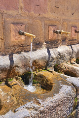 Taps, holy water and city with old structure, wall and Ronda with spiritual cleansing, Andalusia...