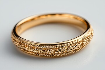 A close-up view of a gold jewelry ring set against a white background, highlighting its intricate design and shine........