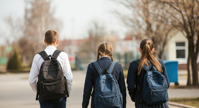 Back to school: Three students walking with backpacks - Powered by Adobe