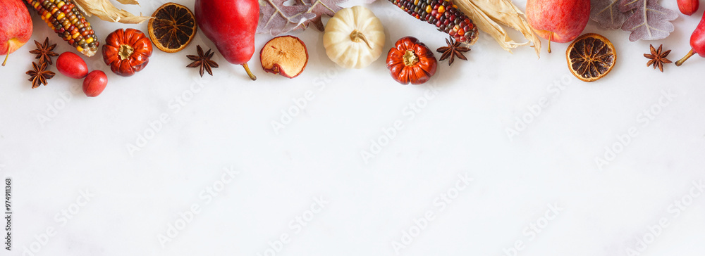 Poster fall border of pumpkins, leaves and autumn baking ingredients. top border on a white marble banner b