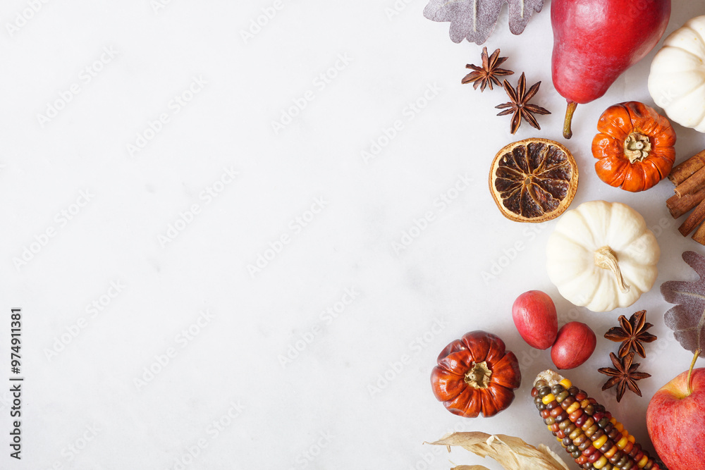 Poster fall border of pumpkins, leaves and autumn baking ingredients. side border on a white marble backgro