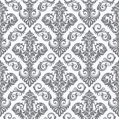 A decorative pattern featuring intricate floral designs in gray tones on a light background.