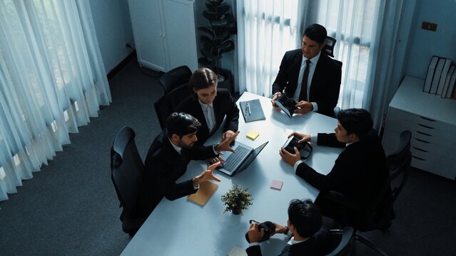 Top view of manager working on laptop and sending data analysis to business people by using VR glass headset while diverse team moving gesture while working together to planning idea. Directorate.