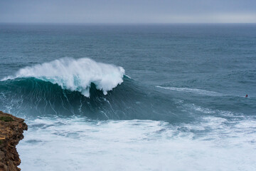 Giant wave breaking in February during the surfing season in Nazare, Portugal