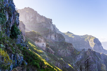 Panoramic view with sun streaks over Curral das Freiras on Madeira island on a bright early morning