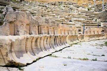 Remains of marble benches from the ancient greek amphitheater of the god dionysus on the hill of...
