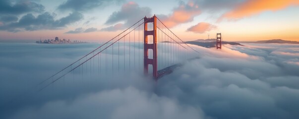 Fototapeta premium A stunning sunrise panorama of the iconic Golden Gate Bridge shrouded in mist, showcasing the beauty of San Francisco's architectural marvel.