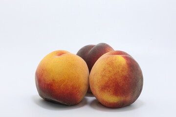 ripe peaches isolated on white
