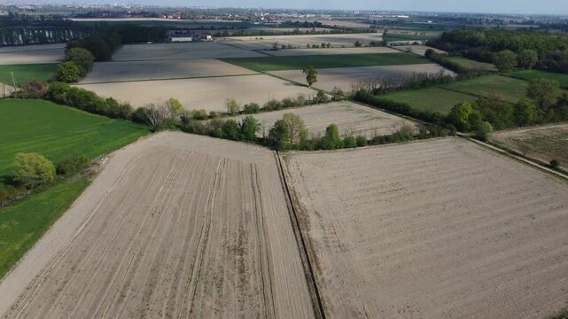 drone shot flying over green fields in the Milanese hinterland