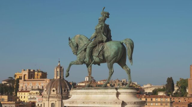 A stunning view of a grand statue to Victor Emmanuel II amidst the historic architecture of Rome