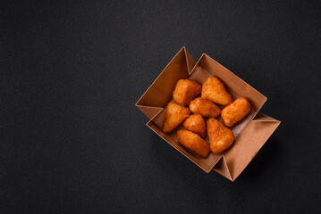 Breaded camembert or brie cheese baked in the form of nuggets with salt and spices