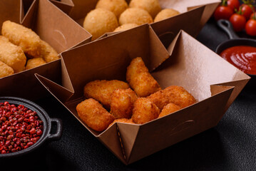 Fast food french fries, brie fries, cheese balls, cheese sticks and chicken nuggets