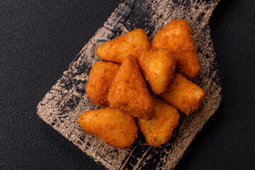 Breaded camembert or brie cheese baked in the form of nuggets with salt and spices