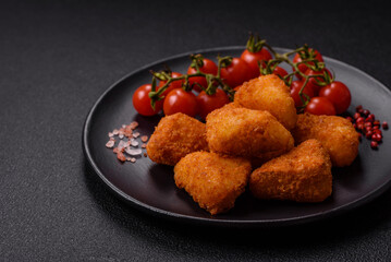 Breaded camembert or brie cheese baked in the form of nuggets with salt and spices