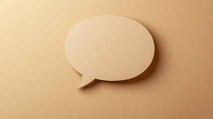 Photo of a speech bubble cut out from light brown cardstock, placed on a bright beige background. Craft speech bubble design.