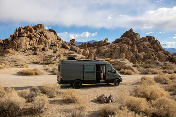 camping in the desert with a camper van and golden retrievers
