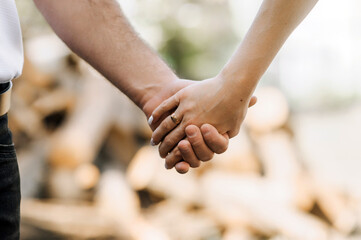 Bride and groom holding hands outdoors. Wedding photography.