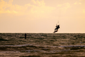 Kite surfing in a windy evening.