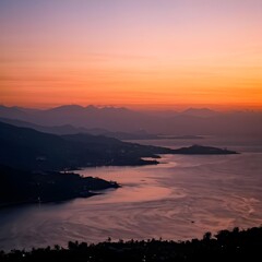 Sun setting behind mountains on the coast