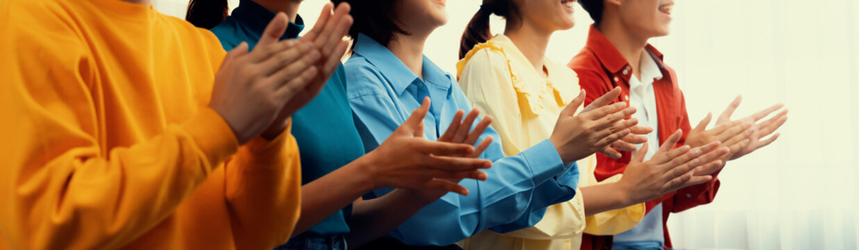 Group of startup company employee gather in line at corporate event to applaud achievement and celebrate company's success or business presentation meeting with audience in panorama banner. Synergic
