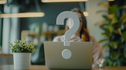A person sits behind a laptop with a large question mark suspended in mid-air, symbolizing inquiry and the search for answers in a modern setting.