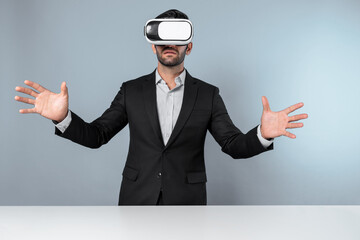 Skilled businessman looking at financial chart while wearing VR goggle. Professional project manager checking data analysis while connecting metaverse or virtual reality world. Innovation. Deviation.