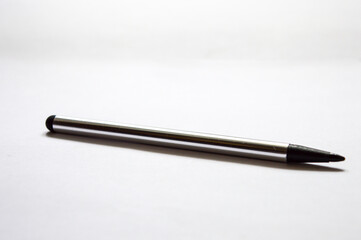 gray black stylus on white background close up photo