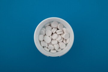 Chlorine tablets in plastic box, top view. Chlorine tablets is used for disinfection of water, for...