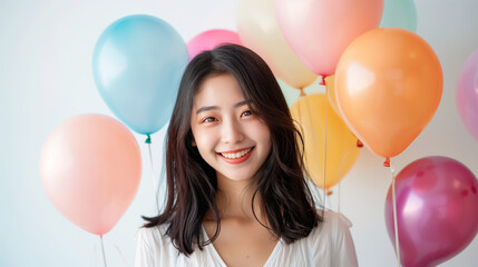 Beautiful fashion model girl with colorful balloons