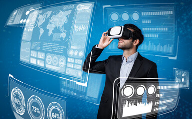 Skilled business man looking data analysis while planning strategy by using visual reality glasses. Professional smart investor checking financial graph holographic while wearing VR goggle. Deviation.