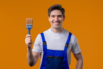 Creative handyman painter artist with brush on orange background. Fantasy, idea © kohanova1991