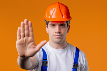 Serious handyman showing Rejecting Gesture By Stop Palm. Not Allow, Prohibition