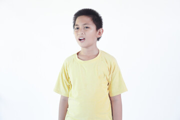 Little asian boy kid wearing casual clothes shouting and screaming loud to side with hand on mouth. communication concept.
