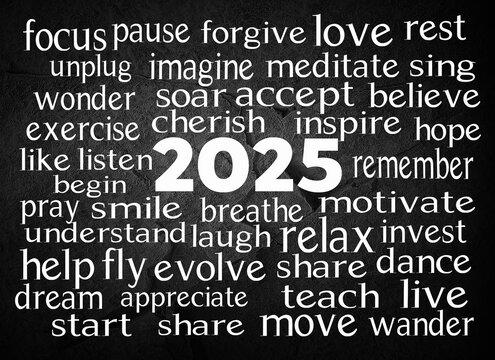 A collection of motivational words surrounds the prominent date "2025" in the center of the image on black slate rock