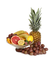 Glass vase with different fresh fruits isolated on white