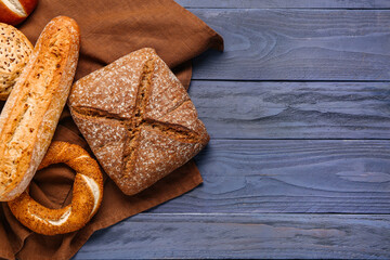 Different types of bread on blue wooden table